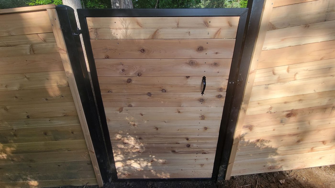 Modern horizontal cedar fence with steel-framed gate